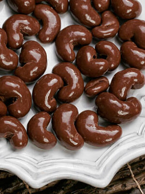 Yummy plate of chocolate covered cashew nuts for sharing or just one.