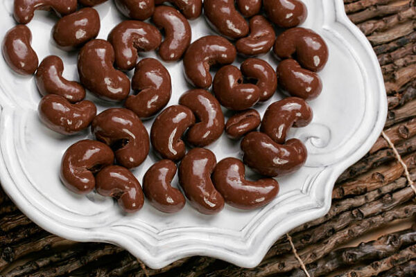 Yummy plate of chocolate covered cashew nuts for sharing or just one.