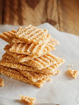 Chopped candied white sesame in stack on wooden background