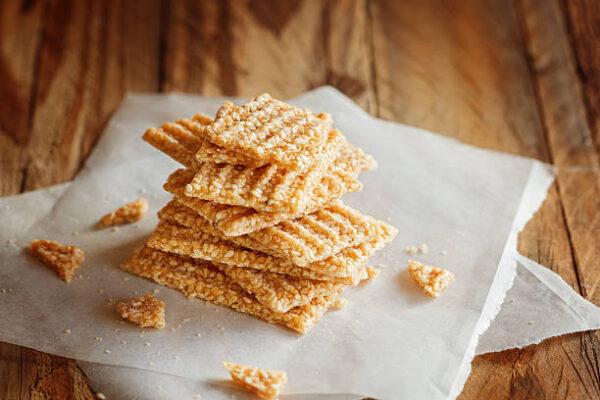 Chopped candied white sesame in stack on wooden background